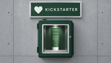 SKØN Repair Microbiome cream in a green glass-front cabinet on grey concrete beneath a KICKSTARTER sign.