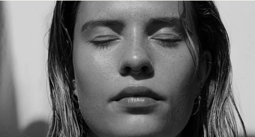 Black and white close-up of a person with eyes closed